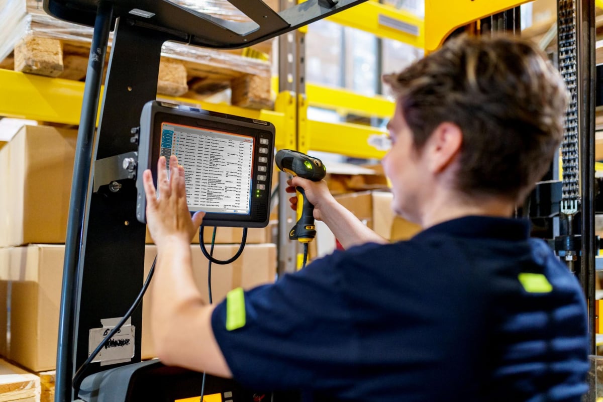 Obatics business management software on a warehouse touchscreen with barcode scanner